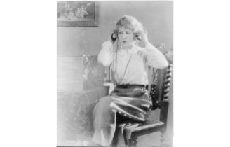 Woman with headphones listening to radio broadcast between ca. 1920 and ca. 1930 Photo by Underwood & Underwood, courtesy Photo courtesy Library of Congress Prints and Photographs Division Washington, D.C. https://www.loc.gov/item/2012649424/