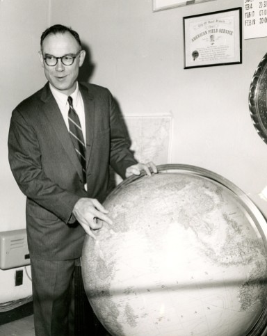 Arthur Howe, Jr. pointing to Iran on a globe during his AFS presidency in 1967. Several years later he traveled to Abbasabad, Iran to give a speech about AFS and its role in international education. Photo courtesy of the Archives of the American Field Service and AFS Intercultural Programs.