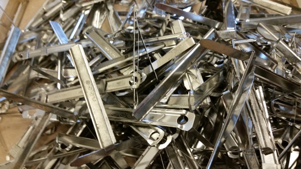 Staples, clips and other fasteners removed from Refugee Resettlement Office files during processing. Photo courtesy the Archives of The Episcopal Diocese of Olympia.