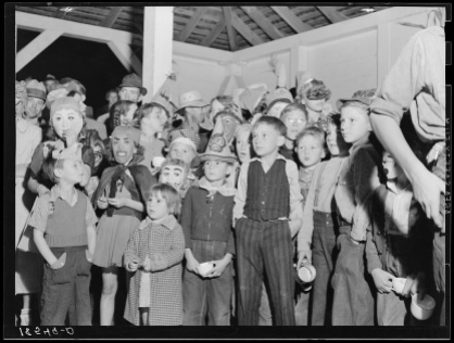 Halloween party at Shafter migrant camp, California, November 1938. Photo by Dorothea Lange, courtesy U.S. Farm Security Administration/Office of War Information/Office of Emergency Management/Resettlement Administration Black & White Photographs, Library of Congress Prints and Photographs Division Washington, D.C. http://www.loc.gov/pictures/item/2017770943/